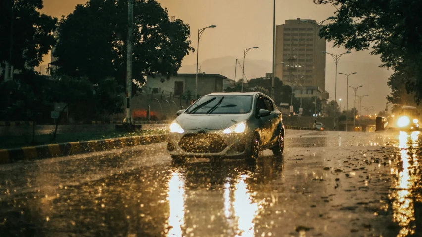 cars drive in heavy rain and rain with lights on