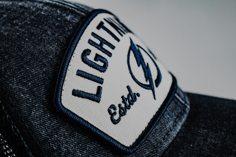 the emblem on a hat reads light and air