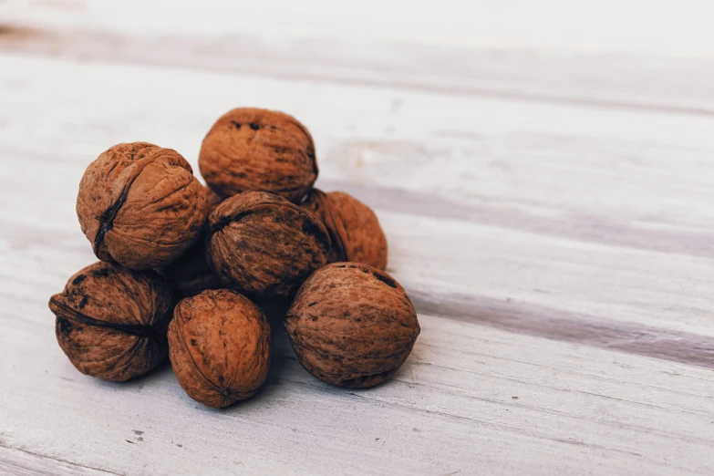 a pile of nuts on top of wooden table