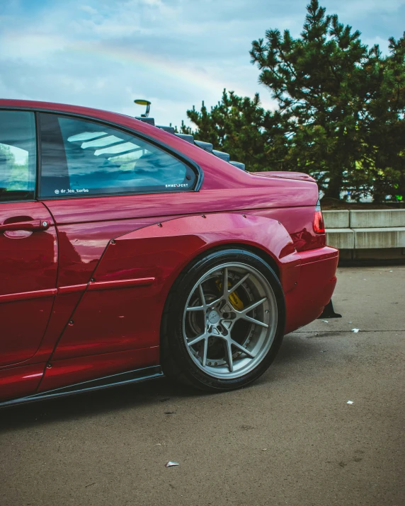 a car with red paint parked in a lot