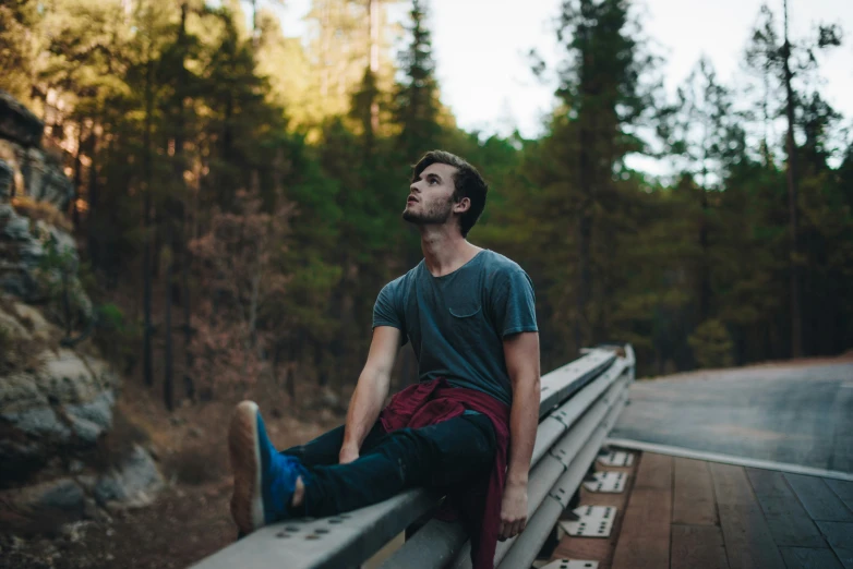 man posing with his feet on the back rail