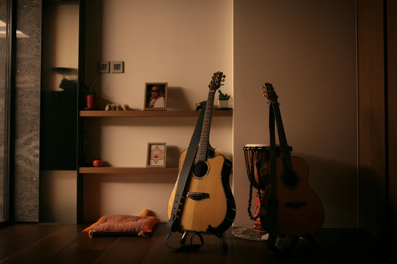 three guitars, and some other instruments lay on a hard wood floor in a living room