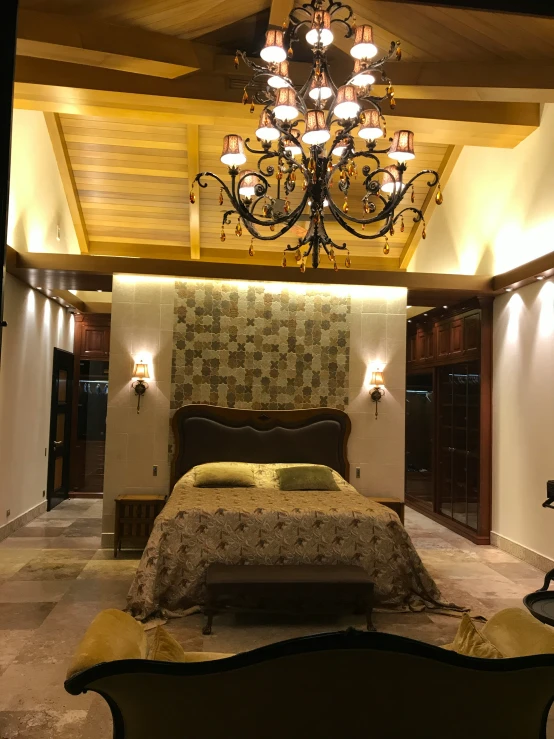 a bedroom with a chandelier over a large bed