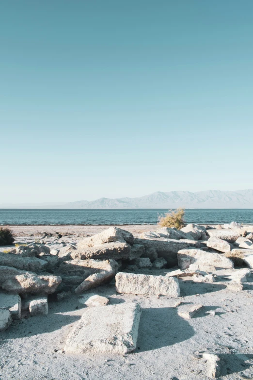 a bench is sitting on the side of rocks near water