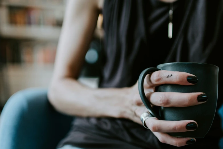 woman holding a coffee cup in her right hand