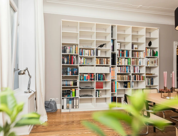 a liry with shelves, a bench and several chairs