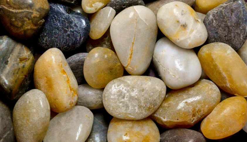 many different colored rocks and stones piled together