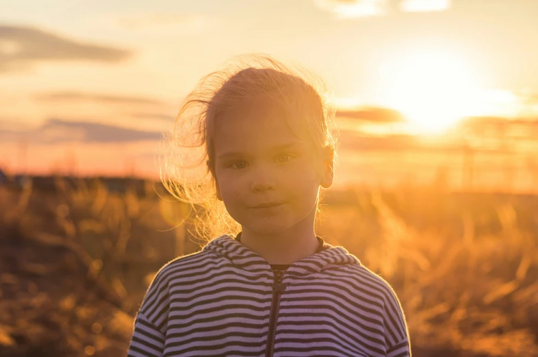 an asian woman standing in the sunset light