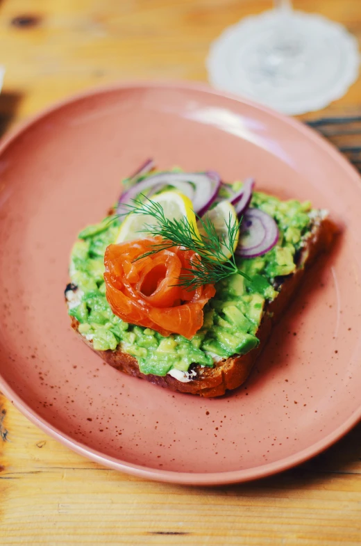 an avocado sandwich on toast with cucumber and tomato