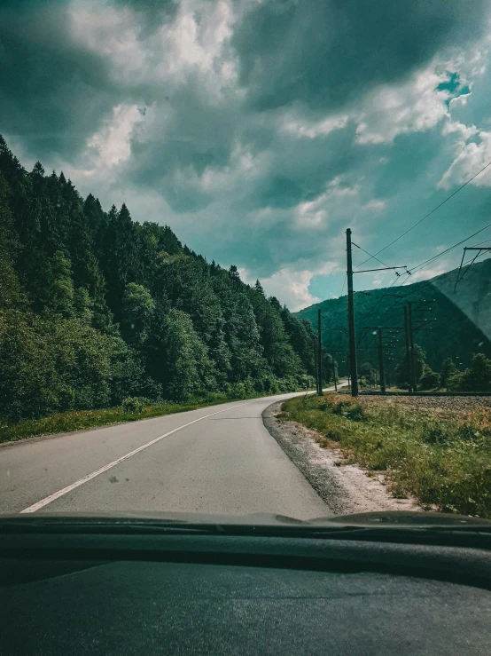 the inside of an automobile looking out onto a road