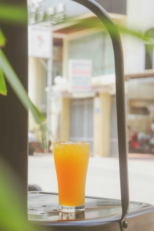 a glass of orange juice sitting on a table