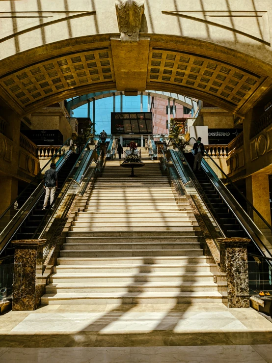 an outside stairway in an old city, with sunlight streaming through