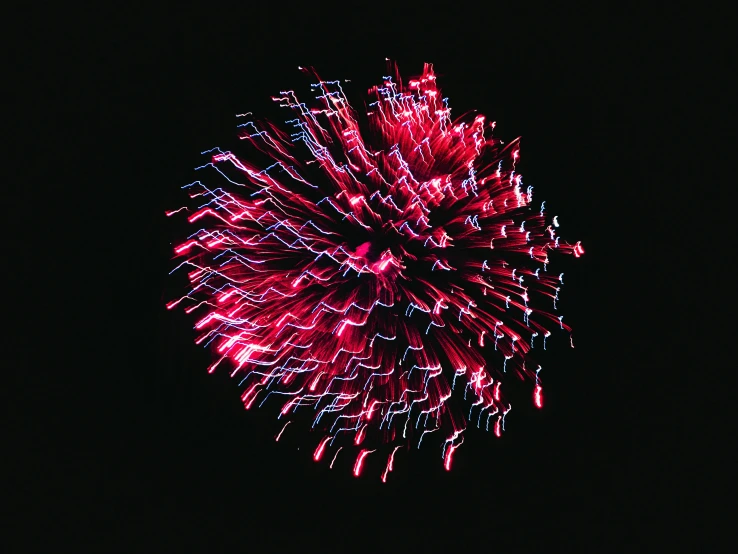a very large red fireworks with many bright lights