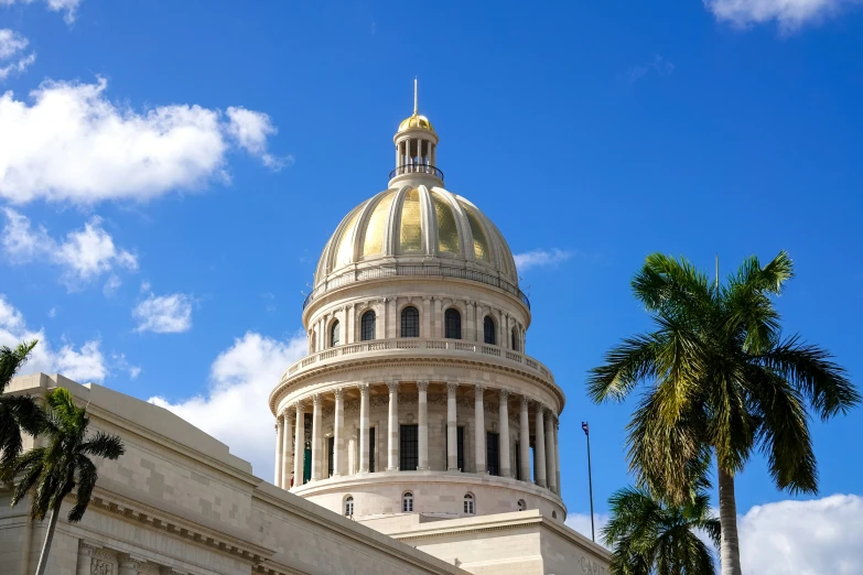 the dome of a large white building under a blue sky