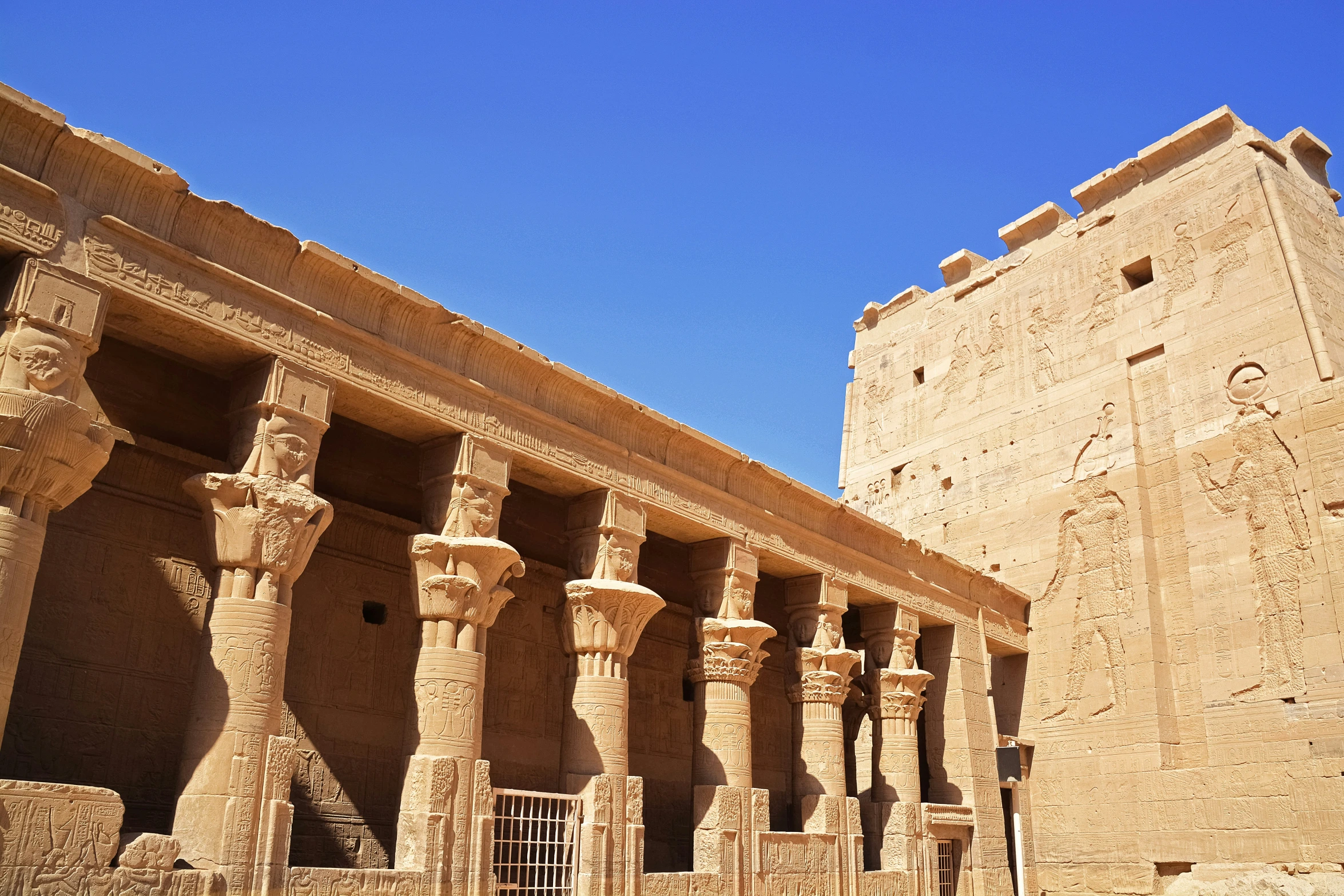 a line of tall brick pillars in a courtyard of an egyptian temple