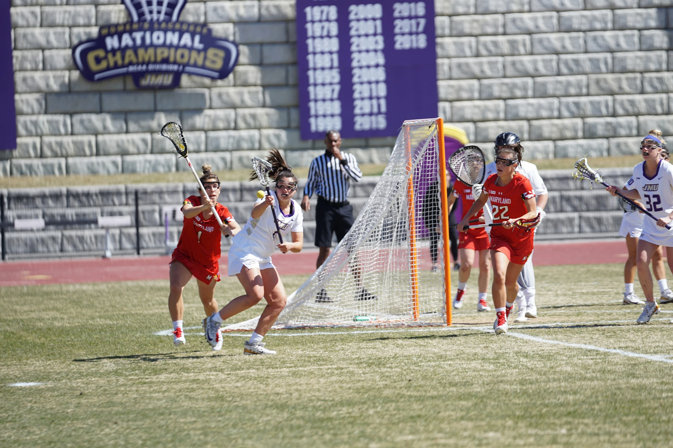 a lacrosse game is being played outside