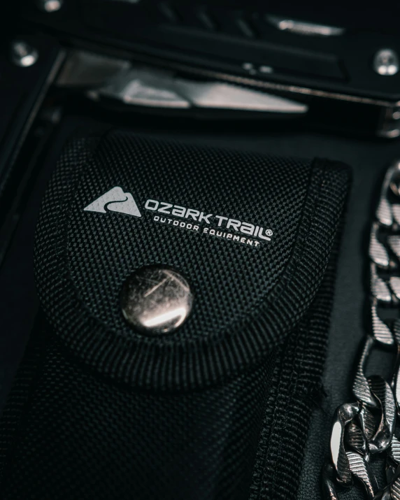 a black pouch sits with some silver metal chains on it