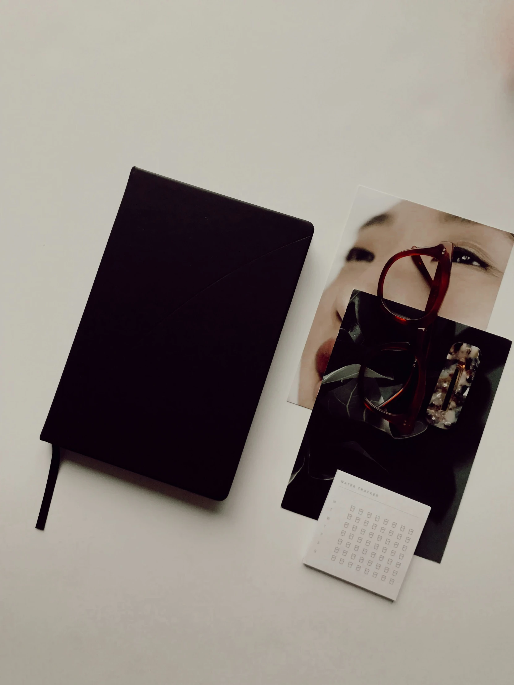 a pograph book on top of a table next to glasses