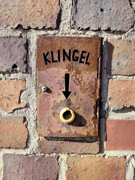 a dead lock sits on a wall with a sign