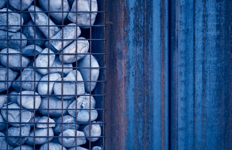 a blue tile is stacked in a wire container