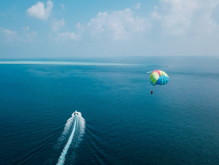 a large kite is being flown over the ocean