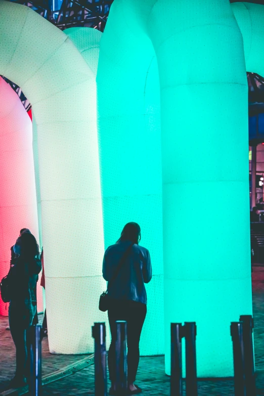 two people looking at large inflatable tubes