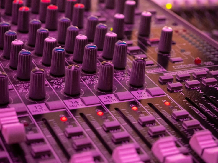 many s on a mixing console in a recording studio
