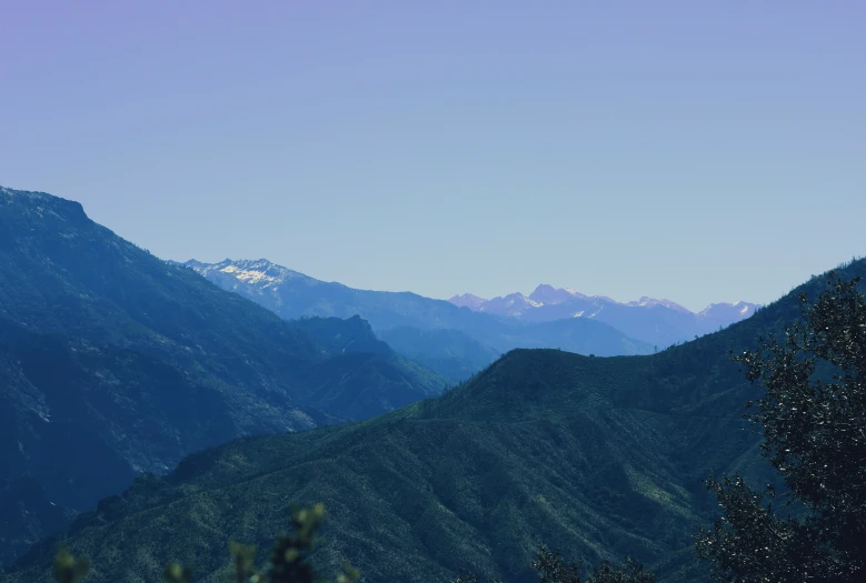 a mountain range with snow on the tops of two large mountains