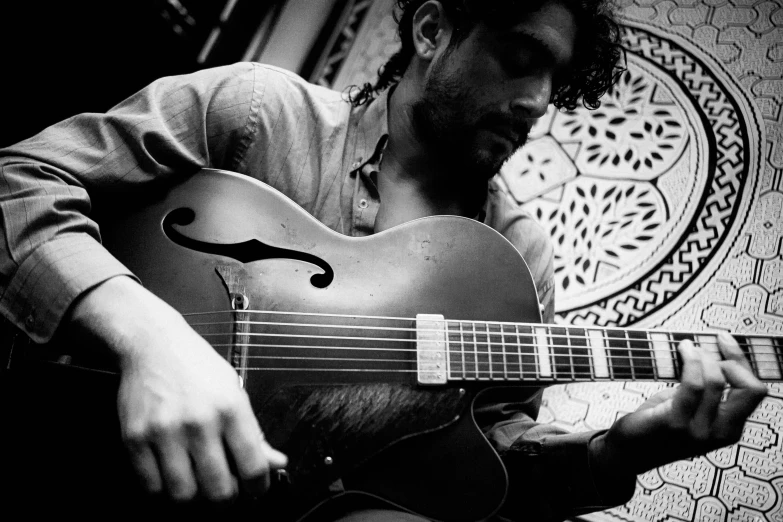 a man with dreadlocks playing the guitar