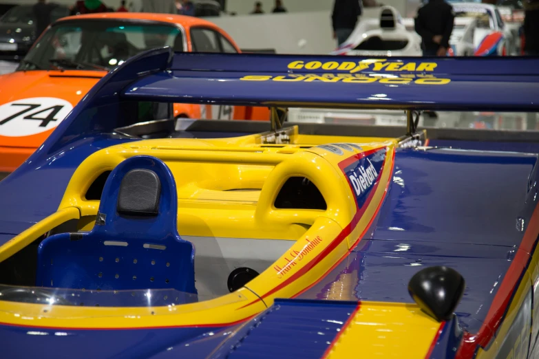 the interior of an automobile show with cars lined up