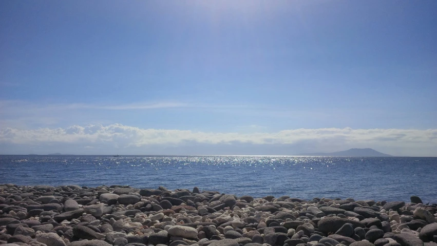 two people are in the distance watching the ocean