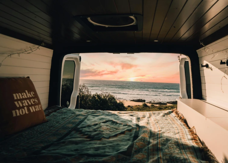 view from inside an rv looking down on the beach