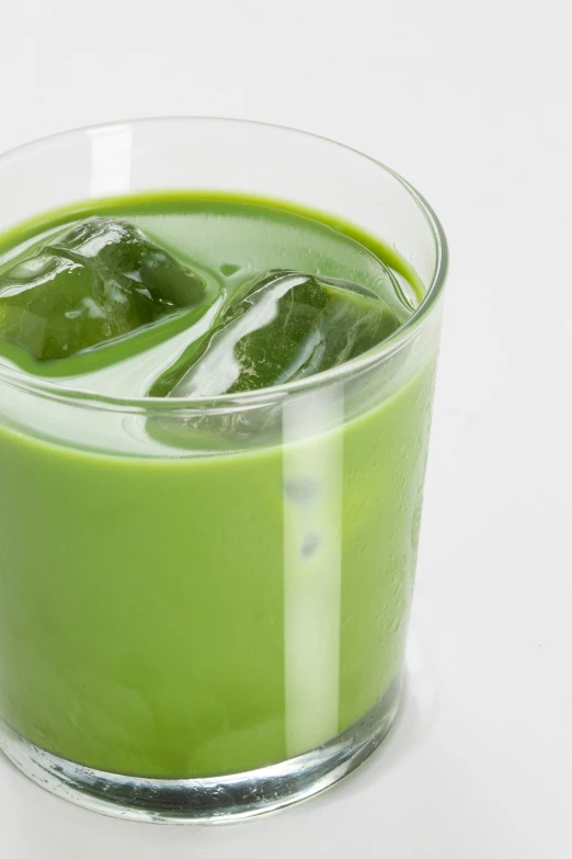 a green liquid with ice cubes in it