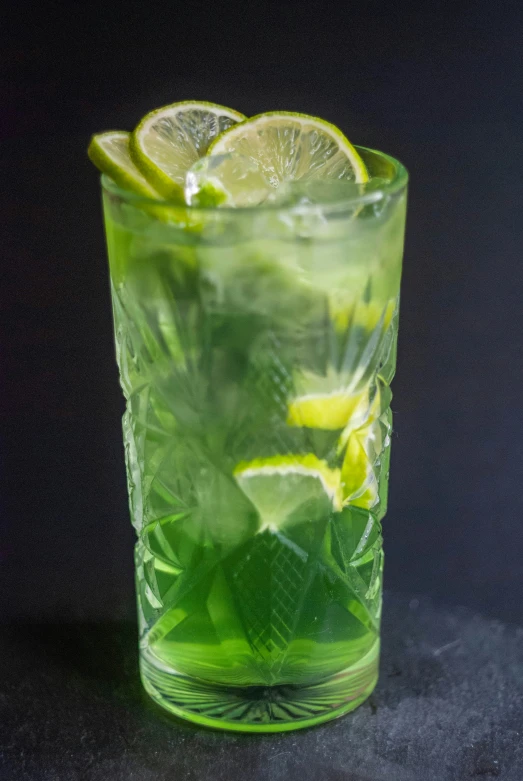 a green drink with limes and mint inside it