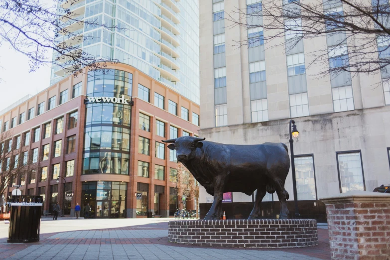 the statue of a bull outside a city building