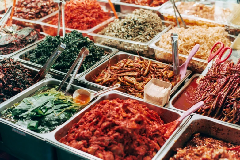 many trays filled with different food items