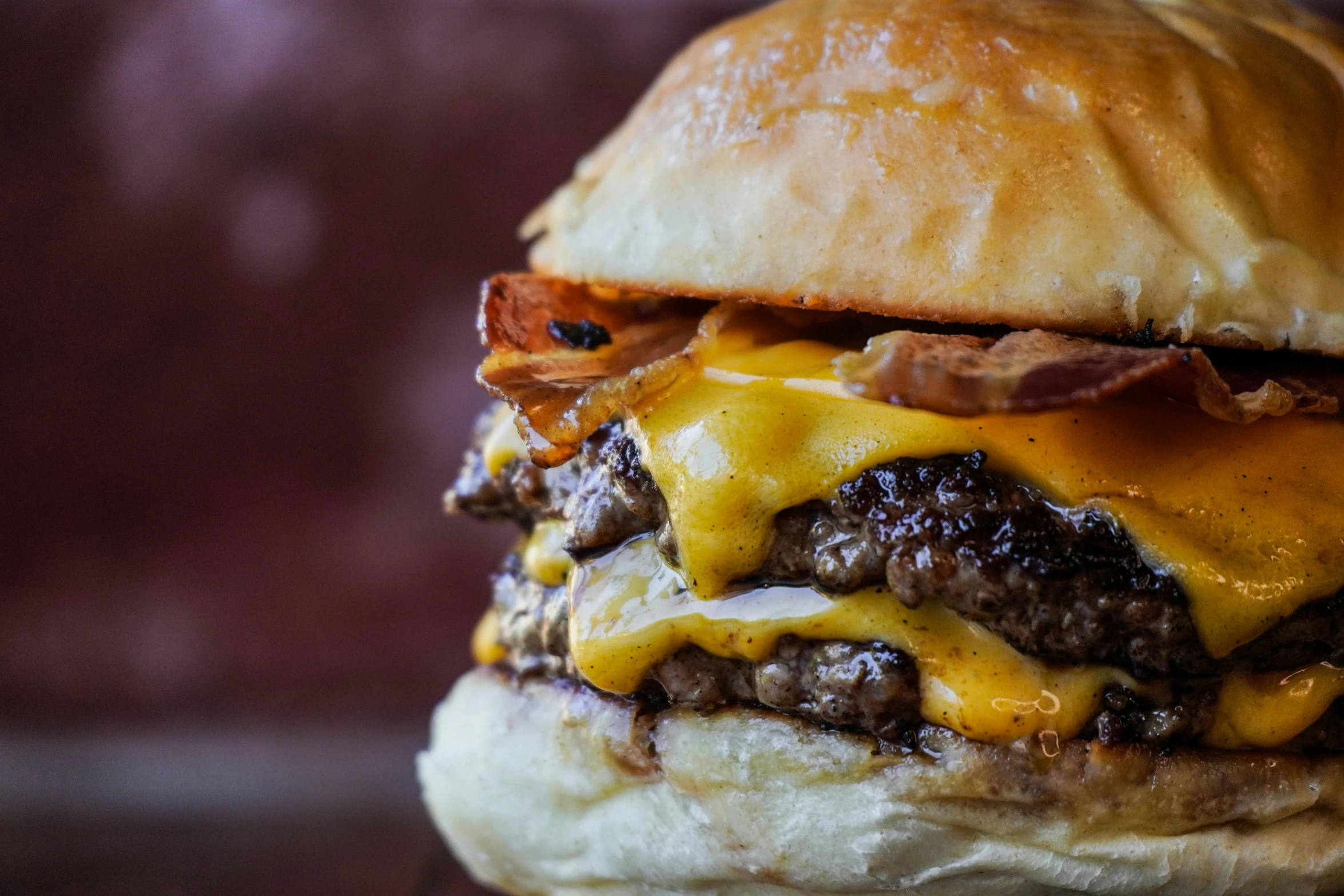 a loaded cheeseburger with bacon and a fried egg