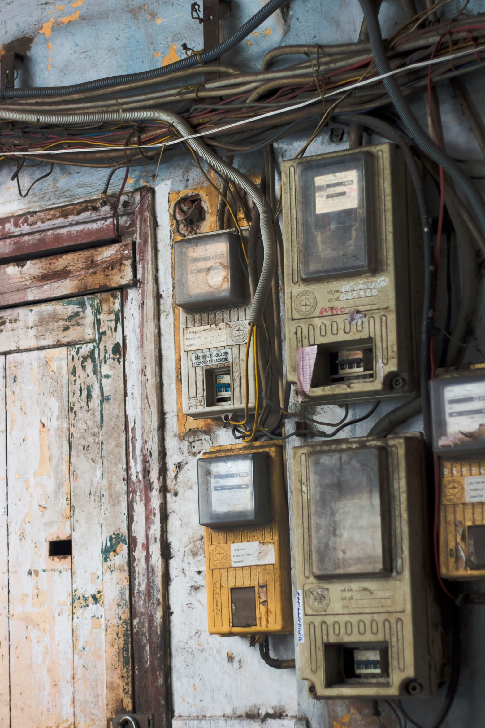 a group of old phones are on a dirty wall