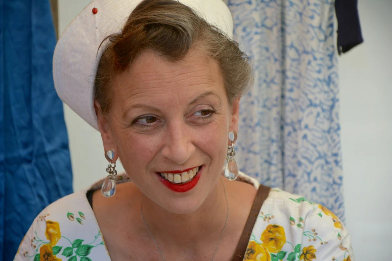 a woman wearing a white hat and smiling