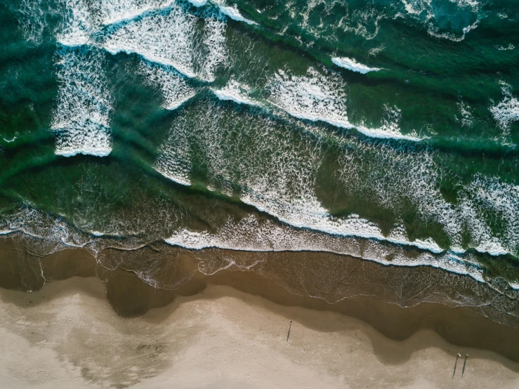 waves washing over the sand and sand at the beach