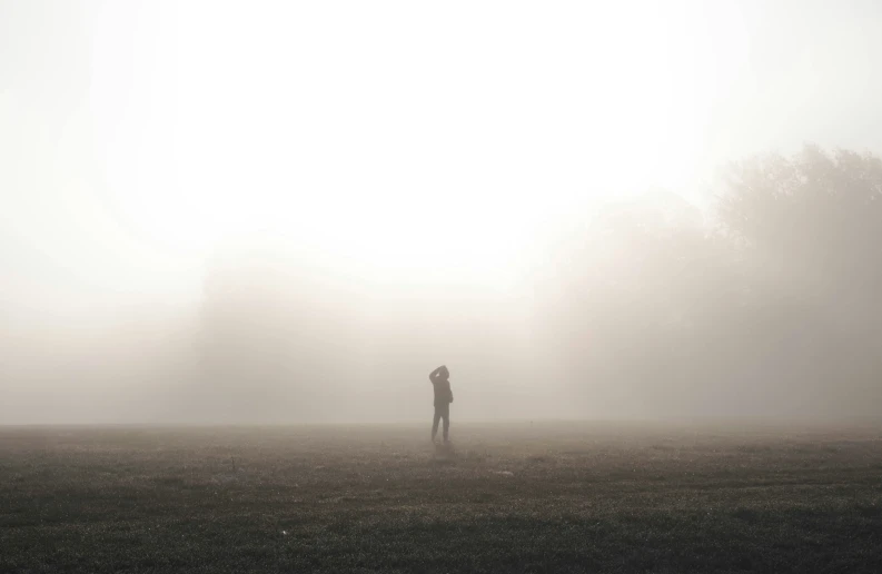 a person is standing in a large field with no one around