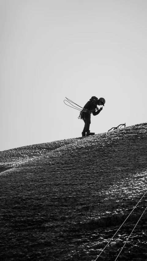 a person holding ski poles up on the side of a hill