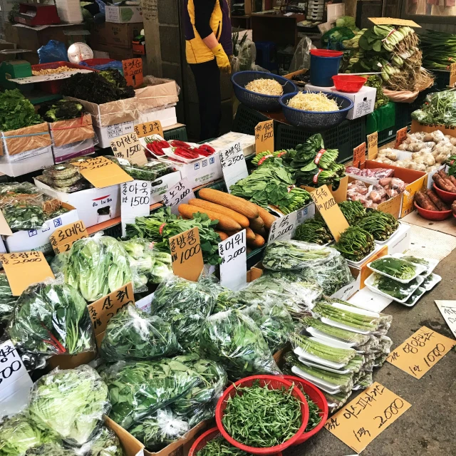 a produce stand with produce for sale in bins and other crates