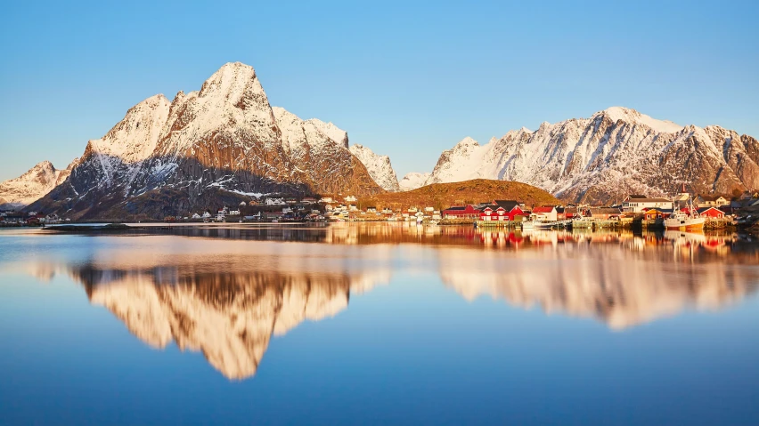 this picture depicts the town of karst in front of snowy mountain peaks