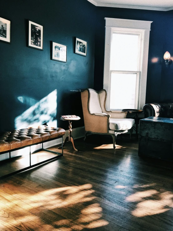 a living room with a couch, table, chairs and a window