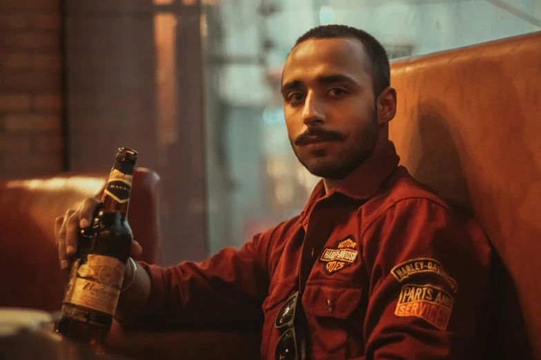 a man sitting in a chair with a beer