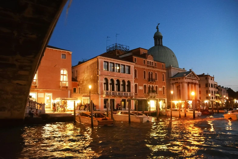 a body of water near buildings and lights