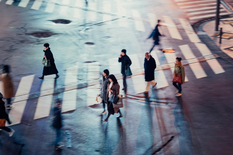 people are walking across an empty cross walk