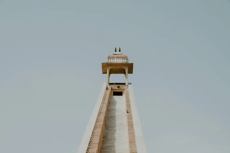 a small tower with a tower top on a cloudy day