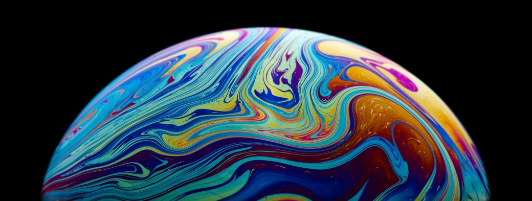 a very colorful, artistically designed egg on a black background